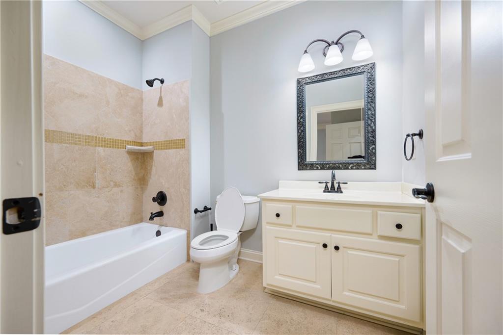2760 Sugarloaf Club Drive Duluth, GA 30097 - Photo 39 of 67 a spacious bathroom with a double vanity sink a mirror and a bathtub