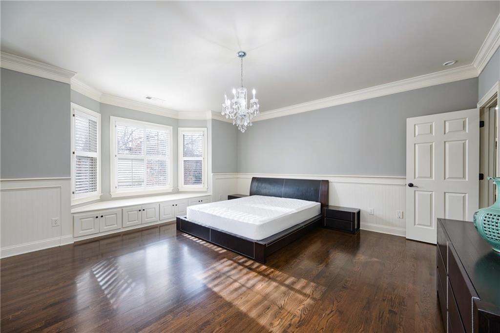 2760 Sugarloaf Club Drive Duluth, GA 30097 - Photo 43 of 67 a bedroom with a large bed and a chandelier