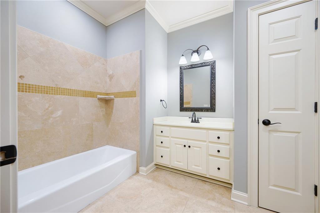 2760 Sugarloaf Club Drive Duluth, GA 30097 - Photo 45 of 67 a bathroom with a bathtub sink and a mirror