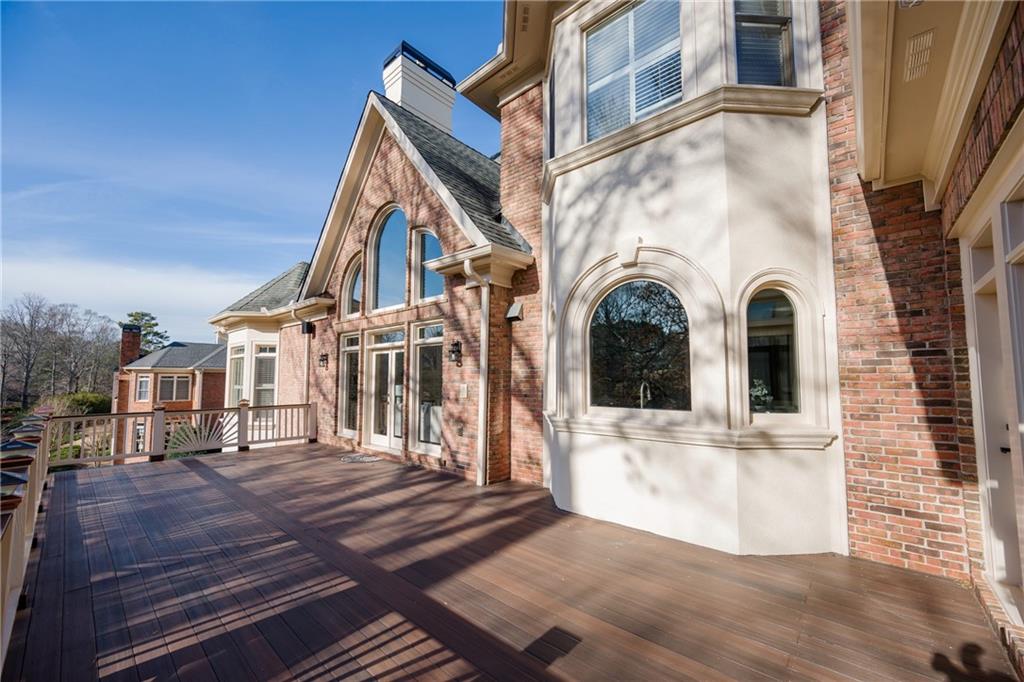 2760 Sugarloaf Club Drive Duluth, GA 30097 - Photo 48 of 67 a view of a brick house with large windows