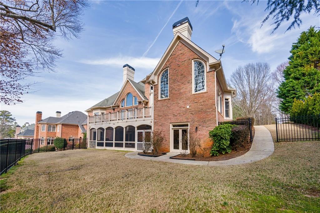 2760 Sugarloaf Club Drive Duluth, GA 30097 - Photo 5 of 67 a front view of a house with a yard
