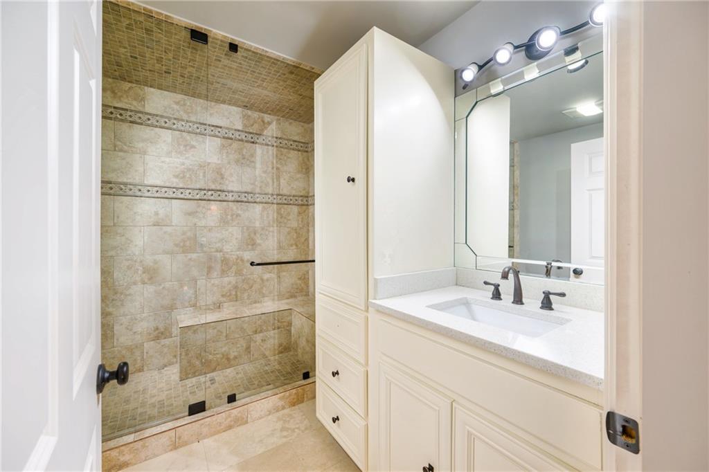 2760 Sugarloaf Club Drive Duluth, GA 30097 - Photo 56 of 67 a bathroom with a shower sink and mirror