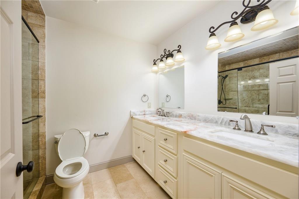 2760 Sugarloaf Club Drive Duluth, GA 30097 - Photo 58 of 67 a bathroom with a granite countertop toilet sink and mirror
