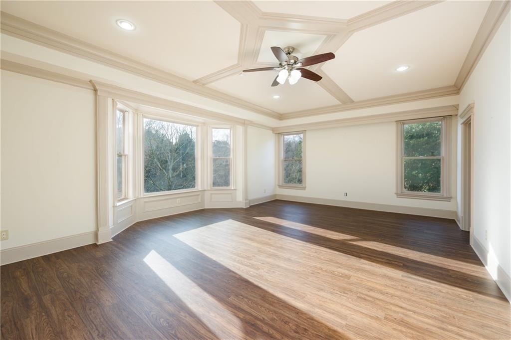 2760 Sugarloaf Club Drive Duluth, GA 30097 - Photo 59 of 67 a view of an empty room with wooden floor and a window