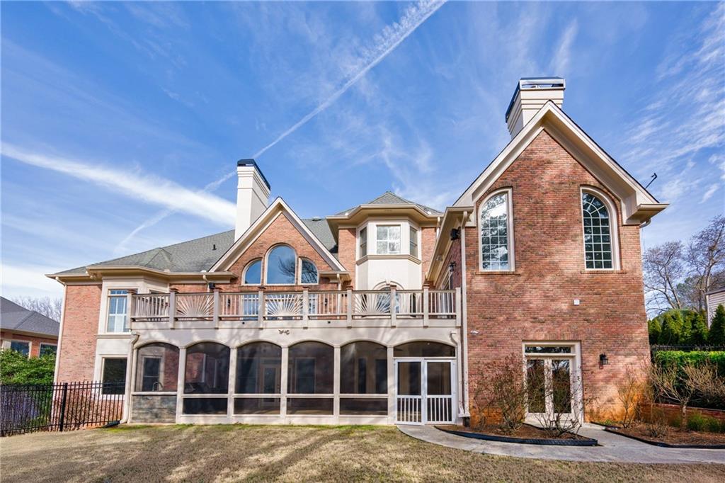 2760 Sugarloaf Club Drive Duluth, GA 30097 - Photo 6 of 67 a view of a brick house with large windows