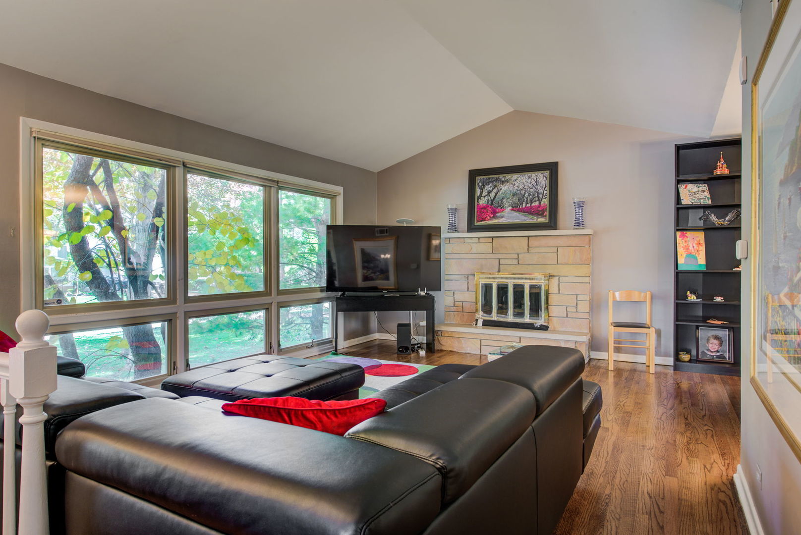 1251 Kenton Road Deerfield, IL 60015 - Photo 2 of 36 a living room with furniture a flat screen tv and a floor to ceiling window