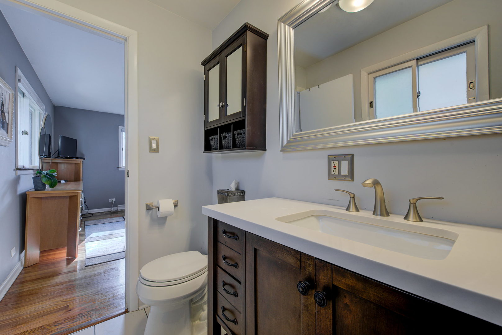 1251 Kenton Road Deerfield, IL 60015 - Photo 15 of 36 a bathroom with a sink and a toilet