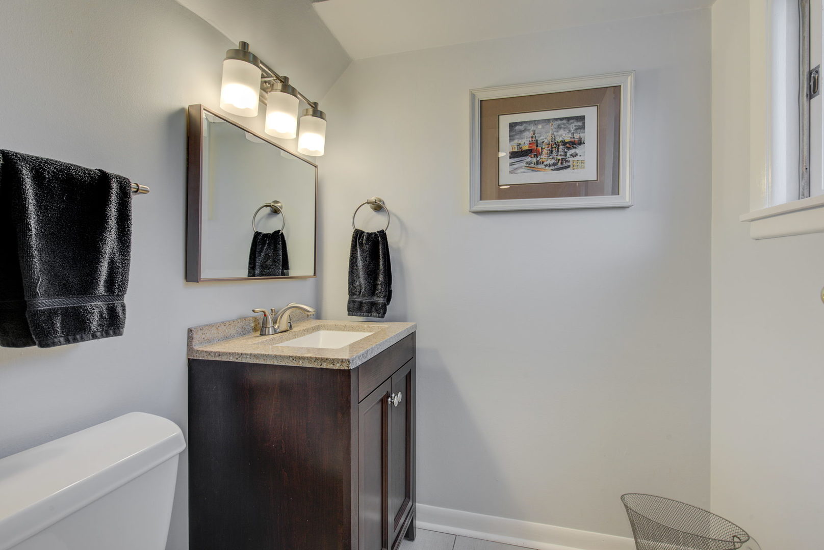 1251 Kenton Road Deerfield, IL 60015 - Photo 22 of 36 a bathroom with a toilet sink and mirror
