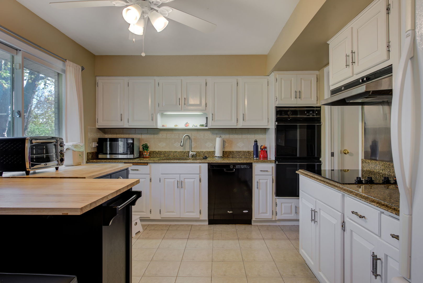 1251 Kenton Road Deerfield, IL 60015 - Photo 7 of 36 a kitchen with stainless steel appliances granite countertop a sink stove and refrigerator
