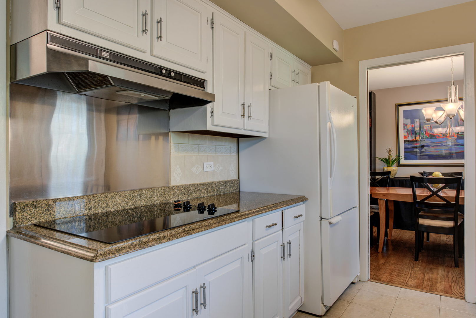 1251 Kenton Road Deerfield, IL 60015 - Photo 9 of 36 a kitchen with stainless steel appliances granite countertop a sink a stove and a refrigerator
