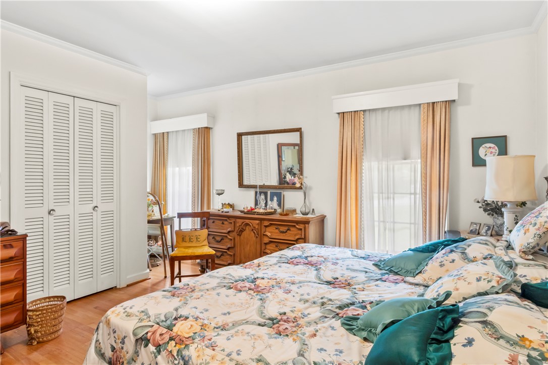118 Blair Road Belton, SC 29627 - Photo 14 of 49 Rich hardwood flooring and classic crown molding elevate this serene bedroom space.
