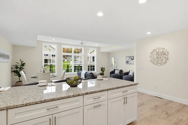 a counter top with granite countertop a sink a mirror and a window