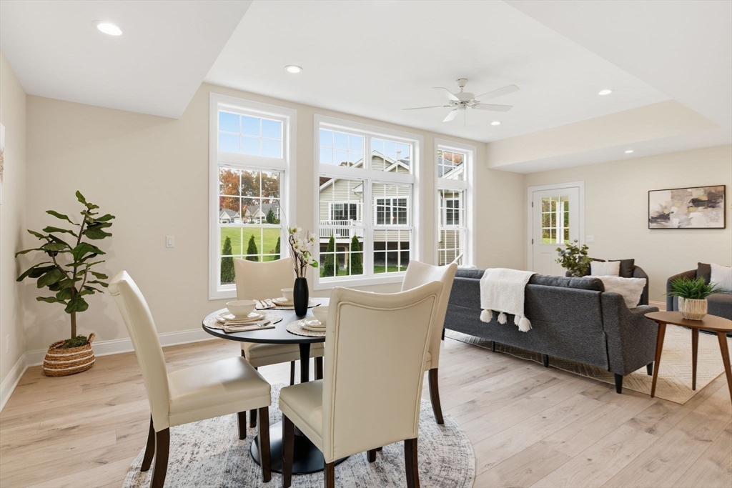 32 Lodge Lane, Unit 32 Wilbraham, MA 01095 - Photo 15 of 42 a living room with furniture potted plant and a large window