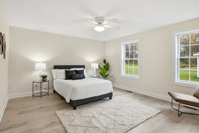 a bedroom with a large bed and a window