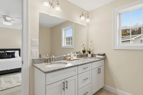 a bathroom with a granite countertop sink a large mirror and a
