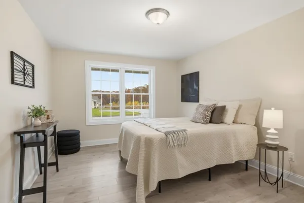 a bedroom with a bed and a window