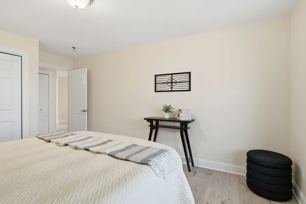 a bedroom with a bed and a chair