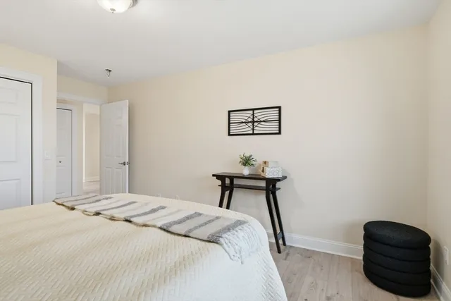 a bedroom with a bed and a chair