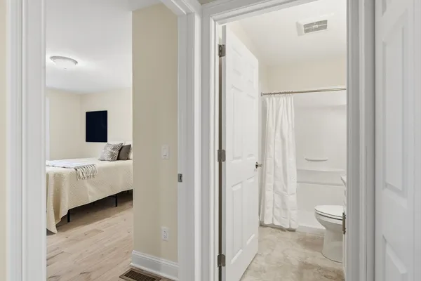 a en suite bathroom with a tub shower and a sink