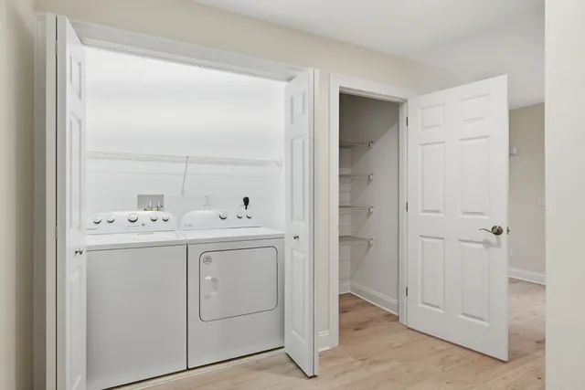 a utility room with cabinets washer and dryer