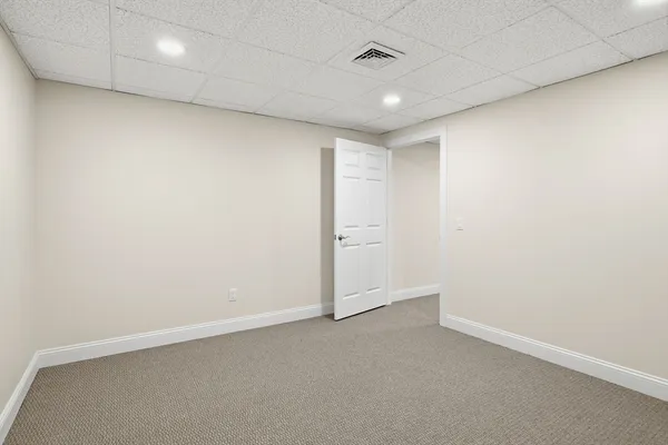 an empty room with a empty space and windows