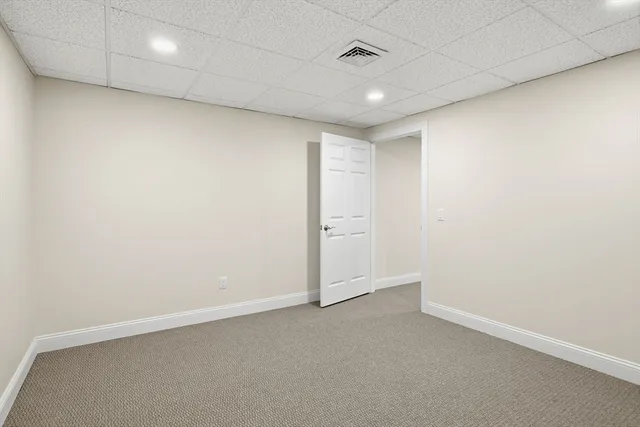 an empty room with a empty space and windows