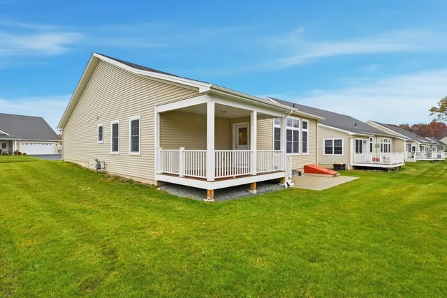 a view of a house with a backyard