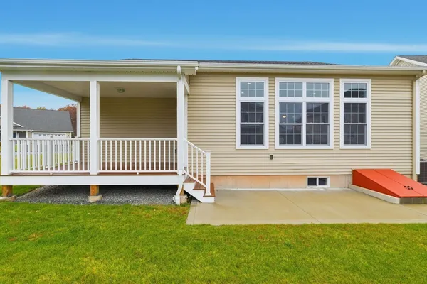 a view of a house with a yard and deck