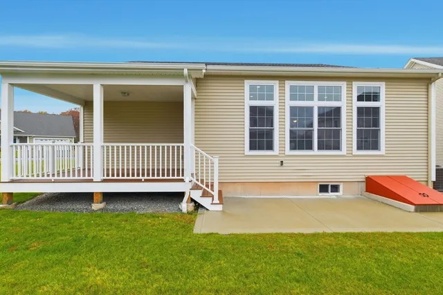 a view of a house with a yard and deck
