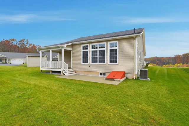 a front view of a house with a garden and deck