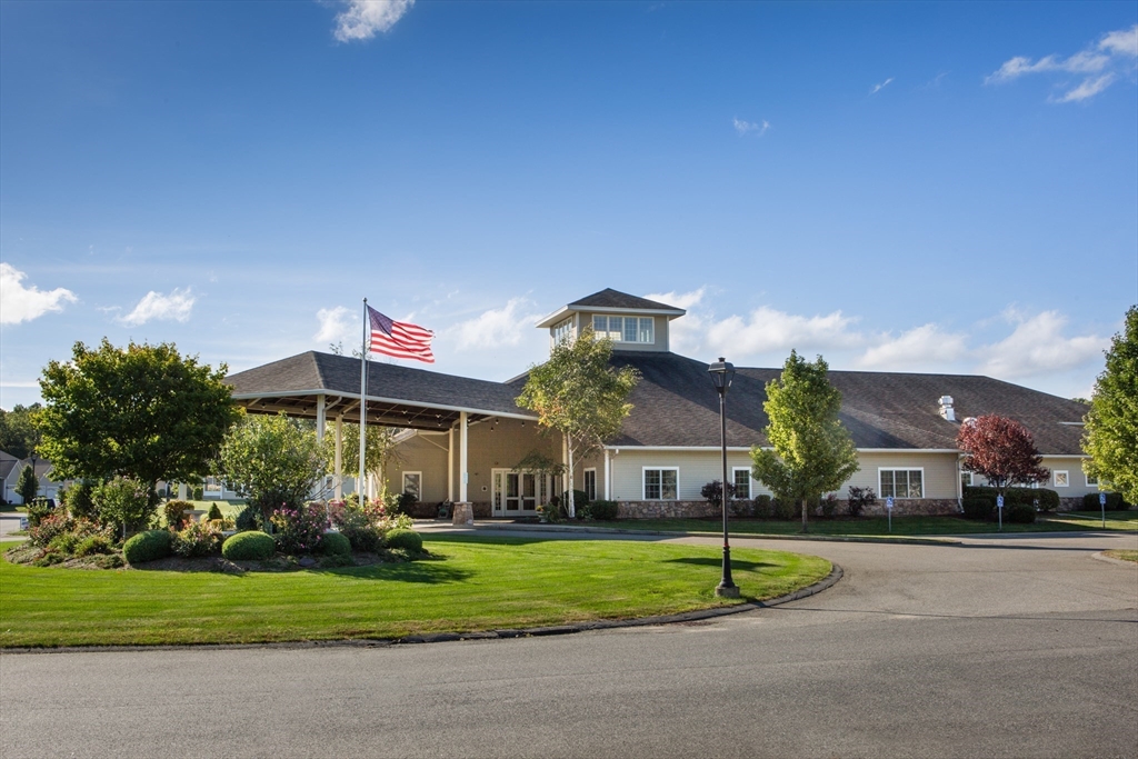 32 Lodge Lane, Unit 32 Wilbraham, MA 01095 - Photo 38 of 42 a front view of a house with a yard and potted plants