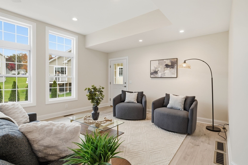 32 Lodge Lane, Unit 32 Wilbraham, MA 01095 - Photo 6 of 42 a living room with furniture and windows