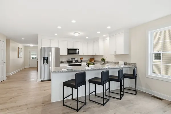 a kitchen with refrigerator and cabinets