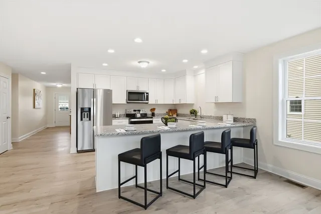 a kitchen with refrigerator and cabinets