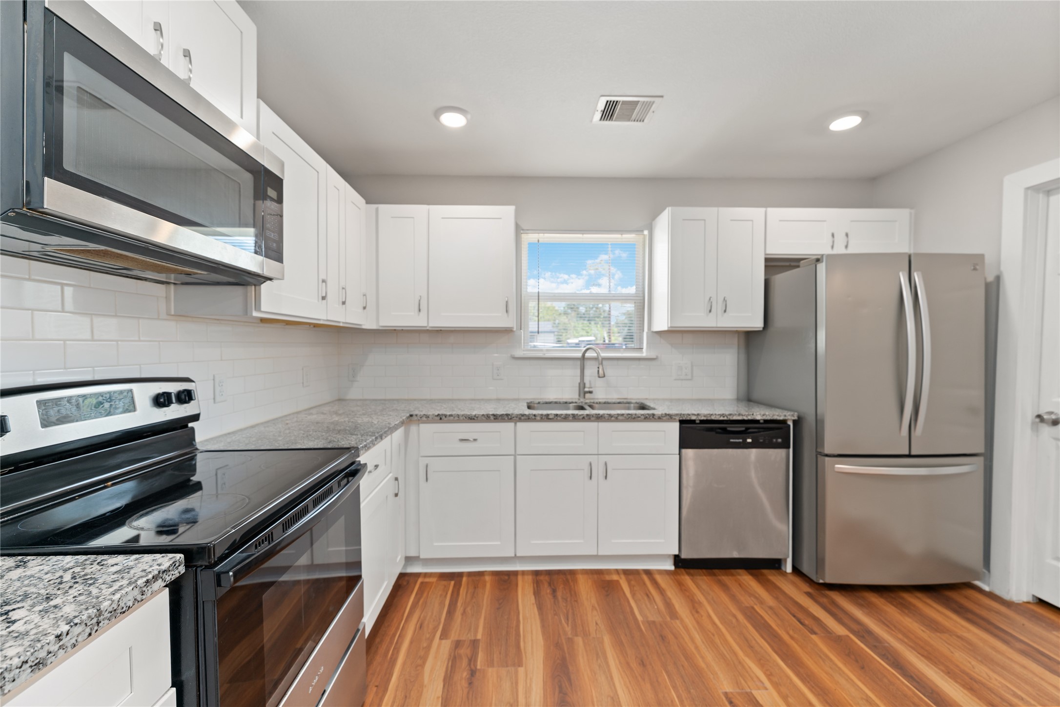 8617 Clarington Street Houston, TX 77016 - Photo 11 of 25 a kitchen with wooden cabinets and stainless steel appliances