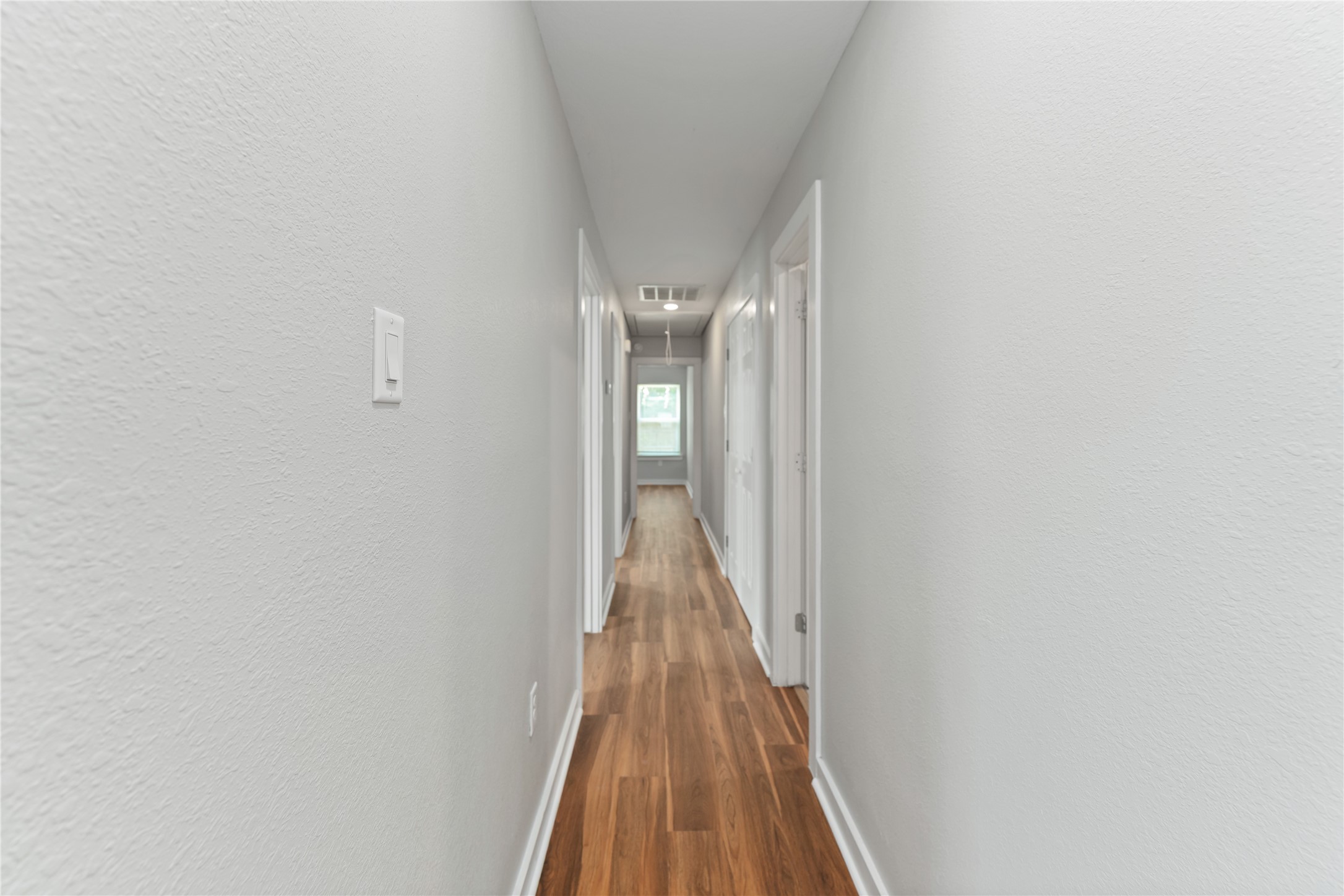 8617 Clarington Street Houston, TX 77016 - Photo 12 of 25 a view of a hallway with wooden floor