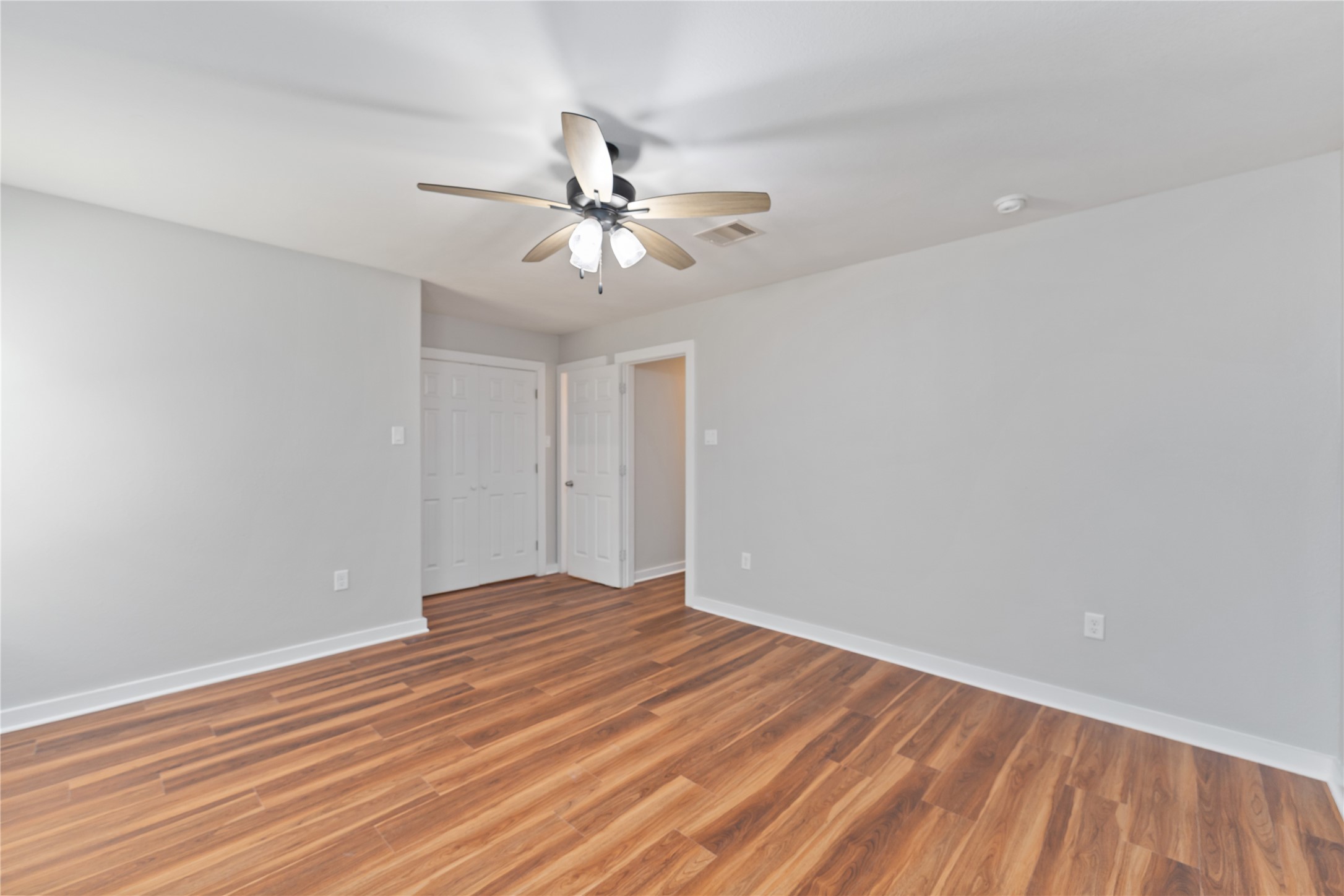 8617 Clarington Street Houston, TX 77016 - Photo 14 of 25 a view of an empty room with wooden floor