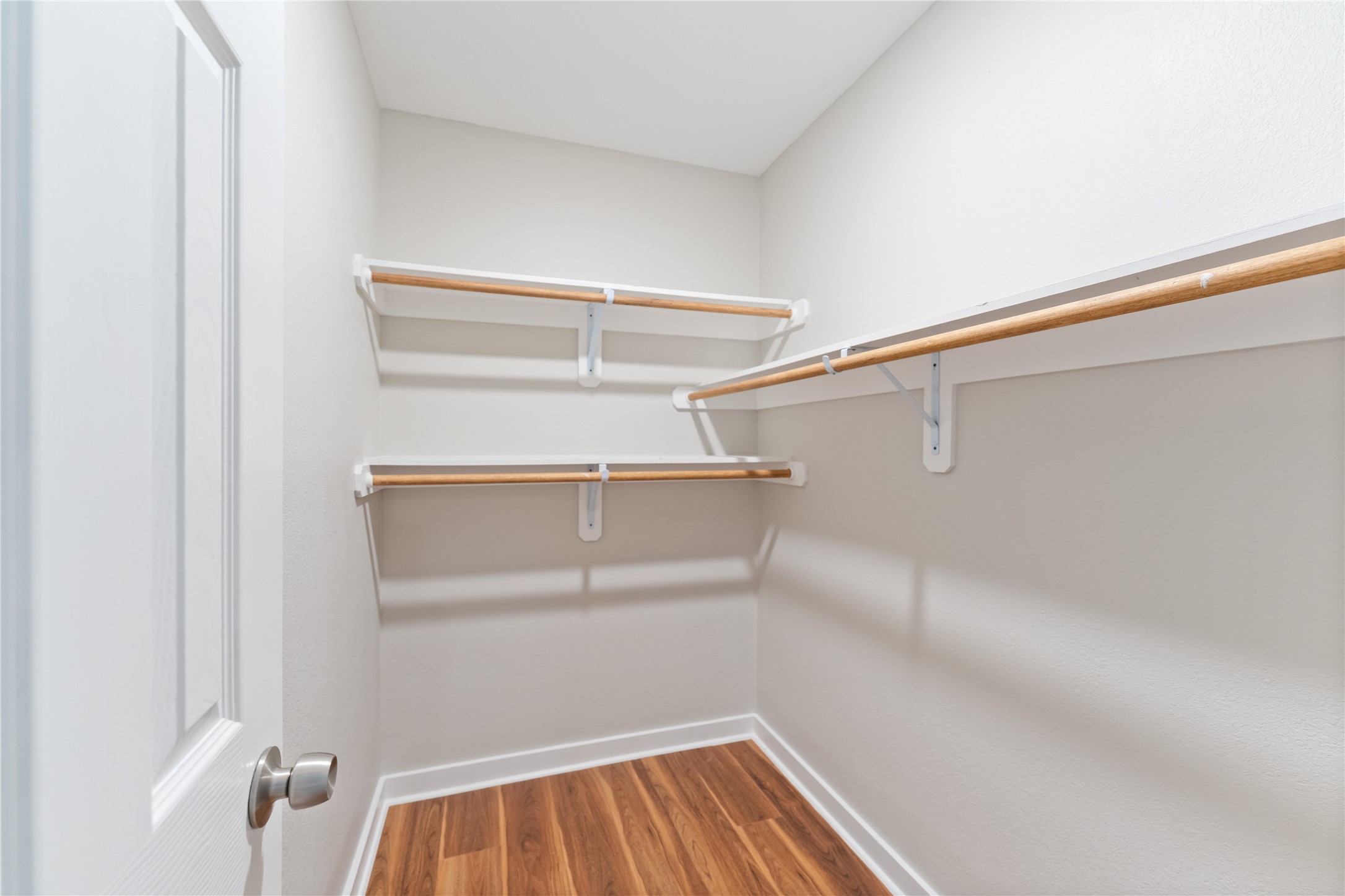 8617 Clarington Street Houston, TX 77016 - Photo 15 of 25 a view of walk in closet with empty racks