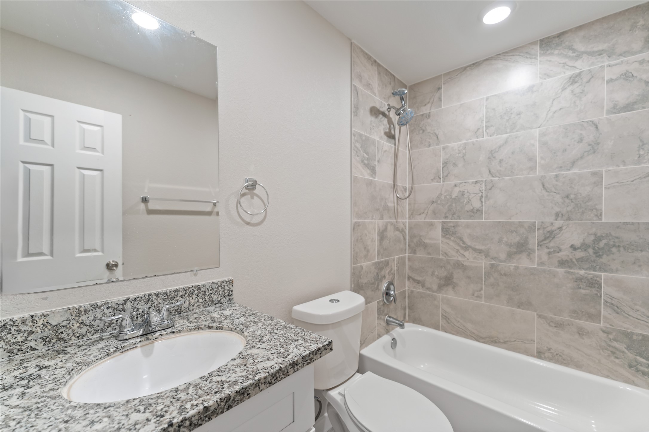 8617 Clarington Street Houston, TX 77016 - Photo 17 of 25 a bathroom with a granite countertop sink toilet and shower