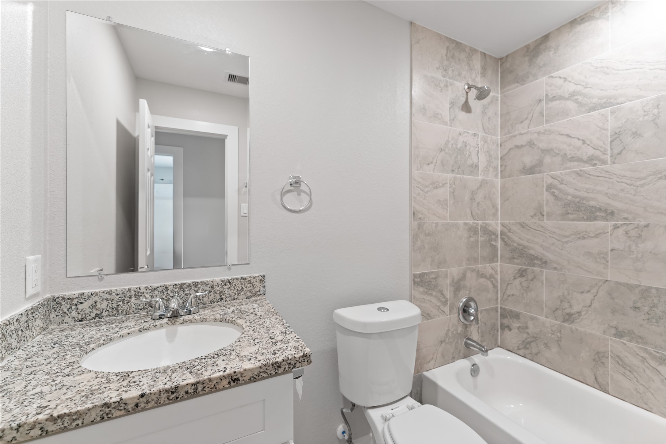 8617 Clarington Street Houston, TX 77016 - Photo 20 of 25 a bathroom with a granite countertop sink a toilet and a mirror