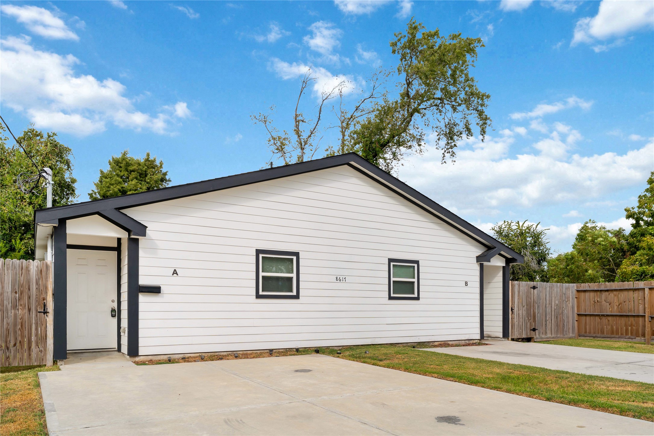 8617 Clarington Street Houston, TX 77016 - Photo 2 of 25 a view of backyard of house with wooden fence