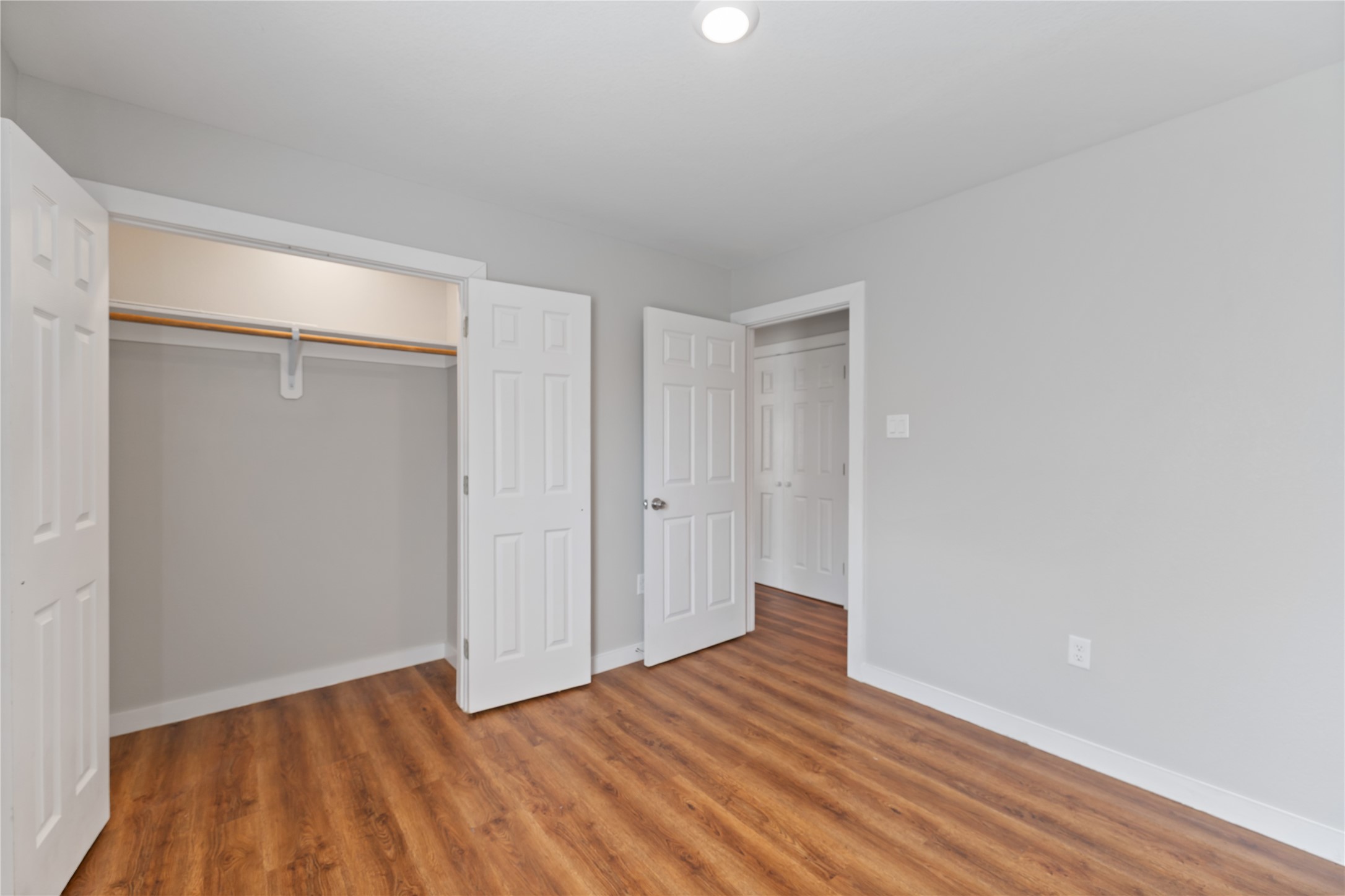8617 Clarington Street Houston, TX 77016 - Photo 22 of 25 a view of an empty room with wooden floor and a window