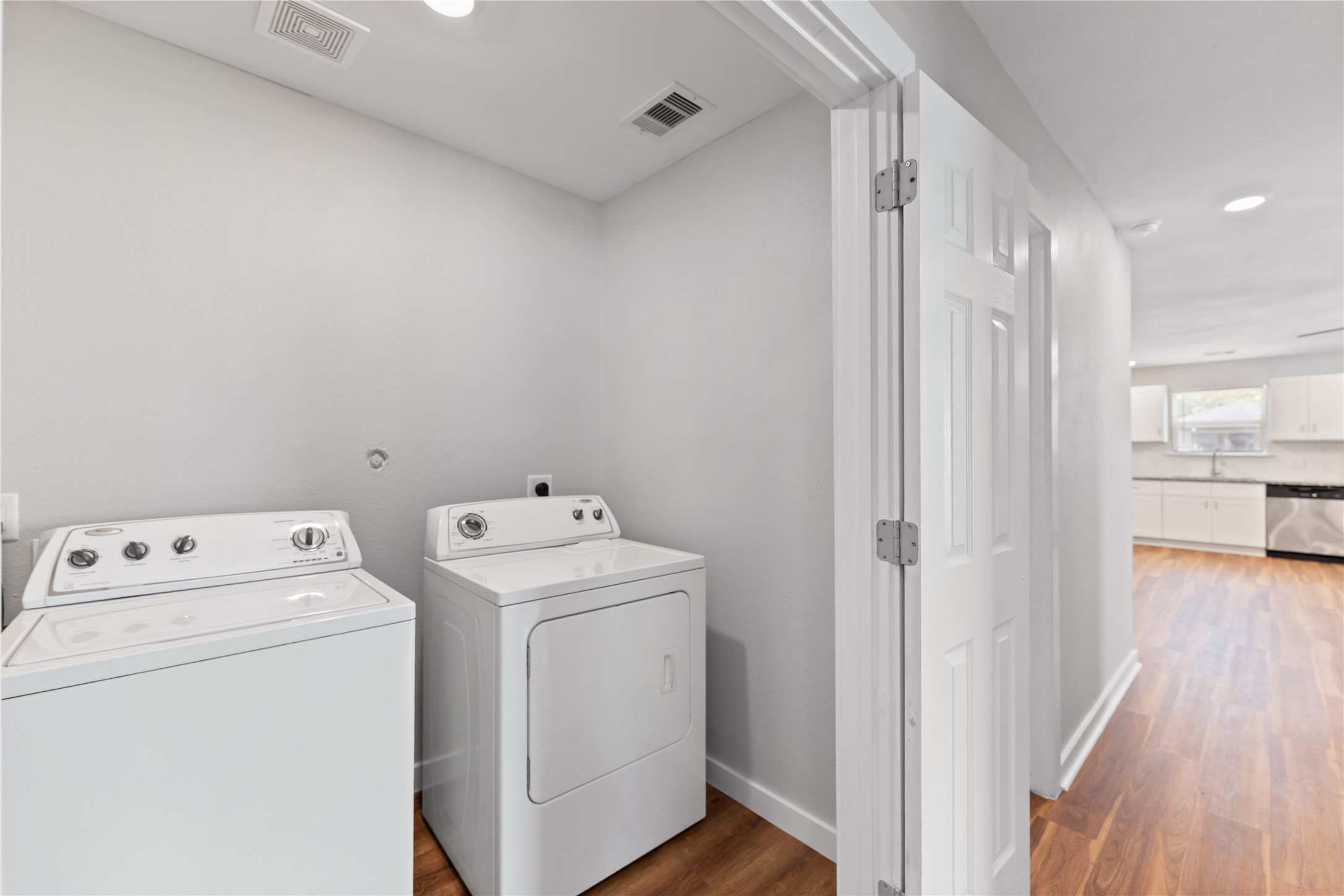 8617 Clarington Street Houston, TX 77016 - Photo 23 of 25 a view of washer and dryer with wooden floor