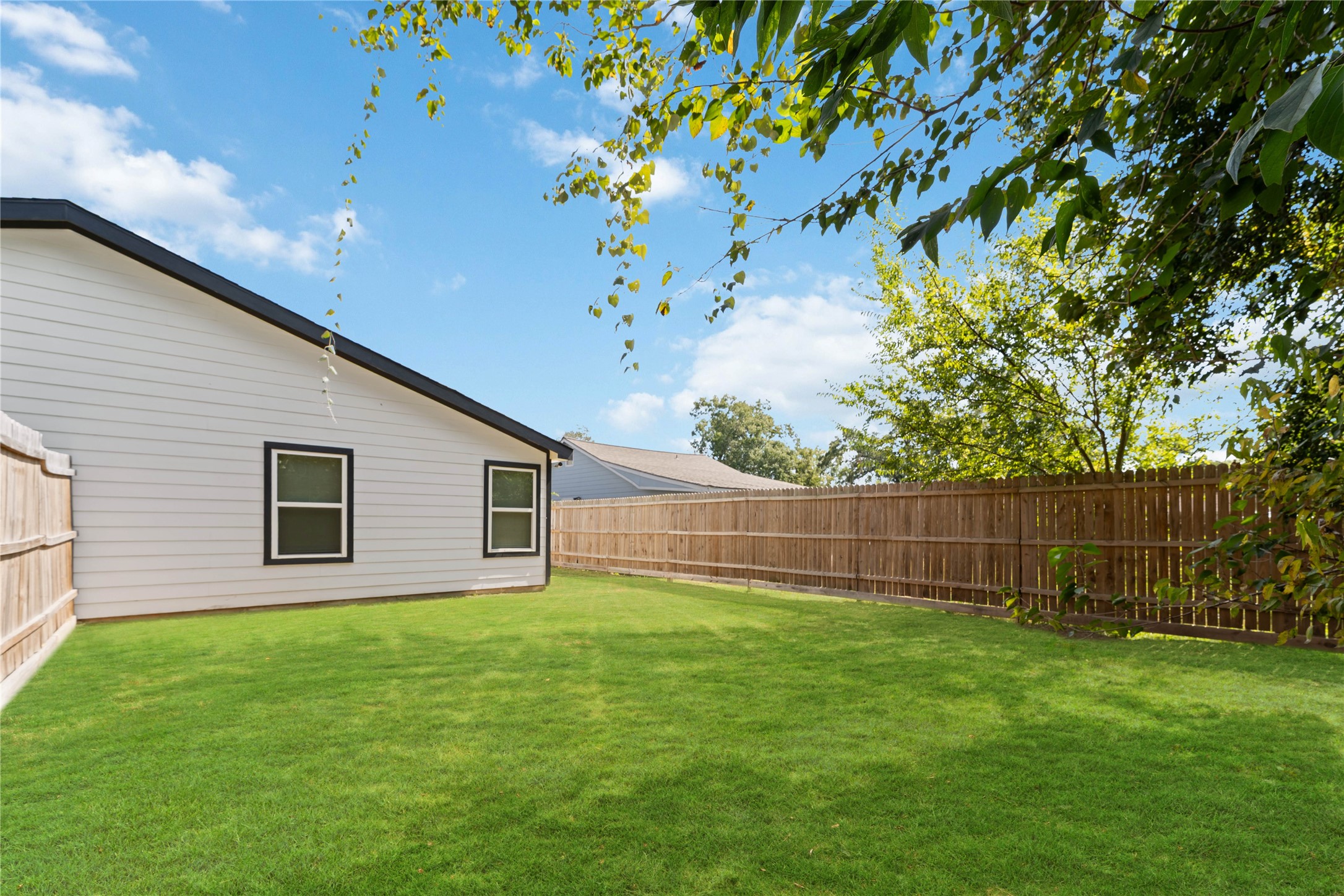 8617 Clarington Street Houston, TX 77016 - Photo 24 of 25 a backyard of a house with lots of green space