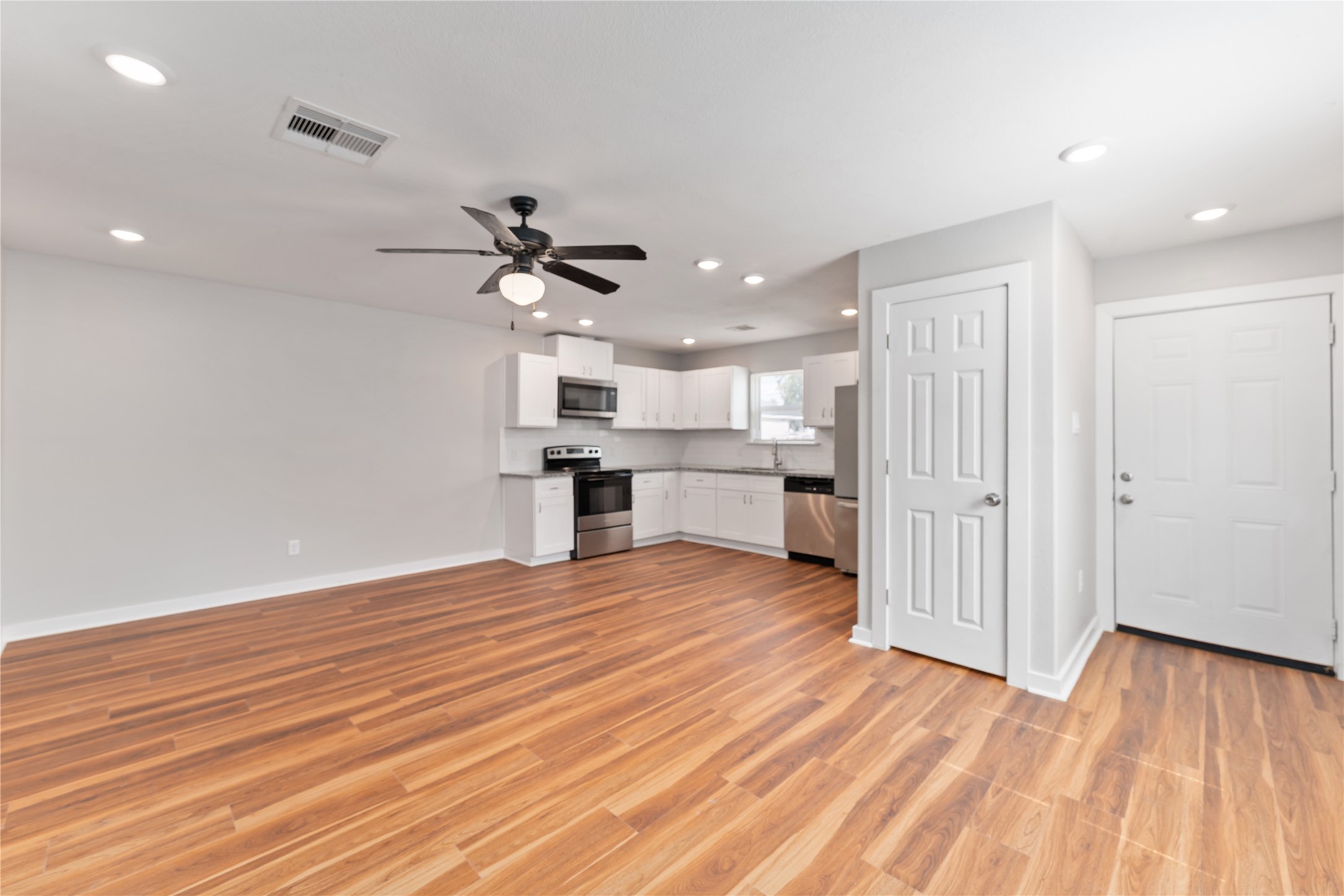 8617 Clarington Street Houston, TX 77016 - Photo 5 of 25 a view of kitchen with cabinets and wooden floor