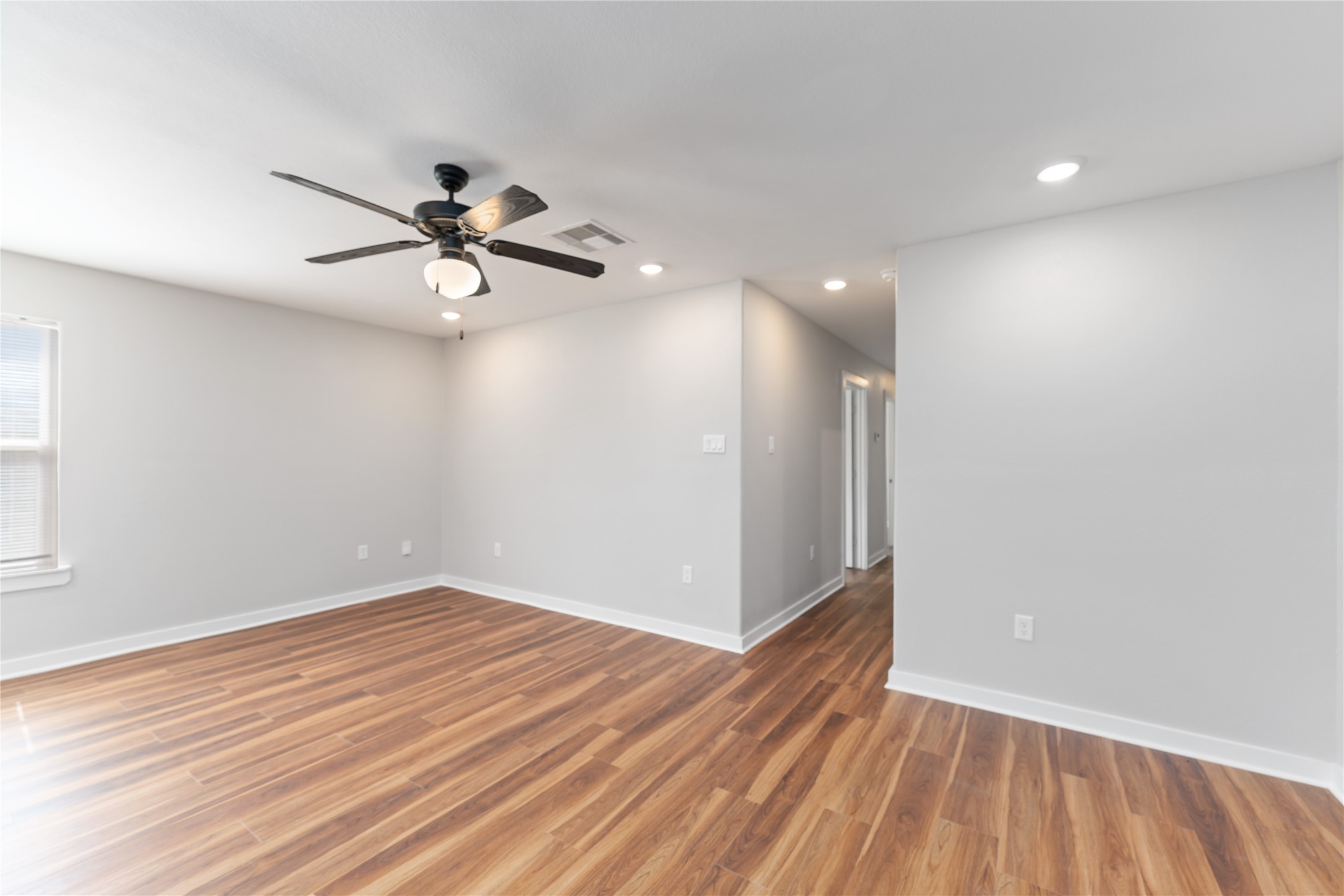 8617 Clarington Street Houston, TX 77016 - Photo 7 of 25 wooden floor in an empty room with a window