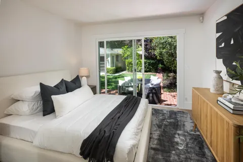 a bed room with a bed and a balcony