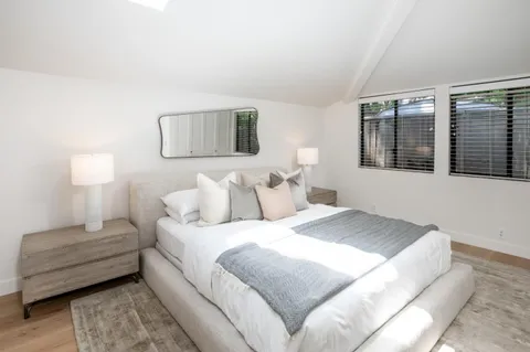 a bedroom with a bed and a couch