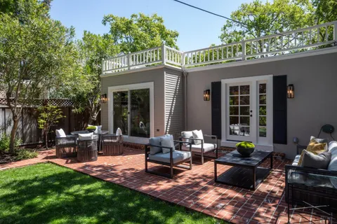 a view of a house with backyard sitting area and garden