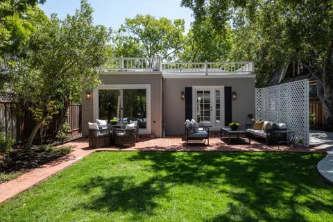 a view of a backyard with table and chairs and a yard